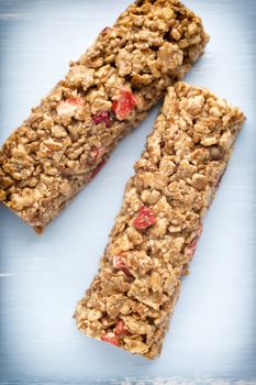 Muesli bars, cereal bars on the wooden background.