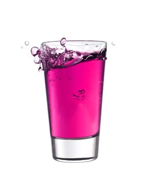 Splash in a glass of pink lemonade isolated on white background