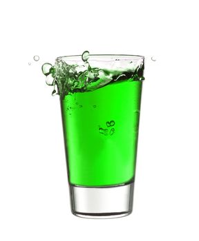 Splash in a glass of green lemonade isolated on white background