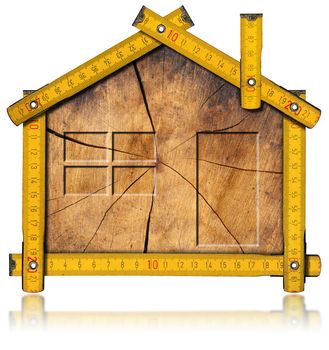 Wooden house project concept. Wooden meter ruler in the shape of house with section of tree trunk inside. Isolated on white background

