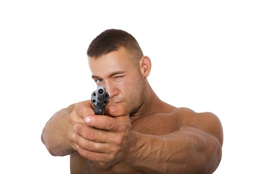 Muscular caucasian man with a gun pointing at camera, isolated on a white background.