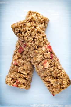 Muesli bars, cereal bars on the wooden background.