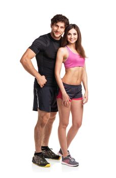 Sport couple - man and woman after fitness exercise on the white background