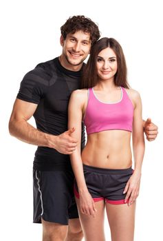 Sport couple - man and woman after fitness exercise on the white background