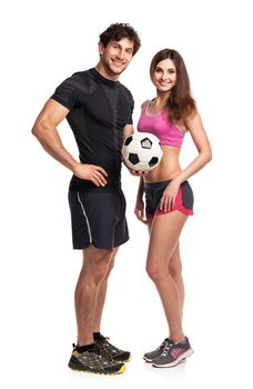 Athletic man and woman with ball on the white background