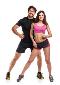 Athletic couple - man and woman with thumb up on the white background