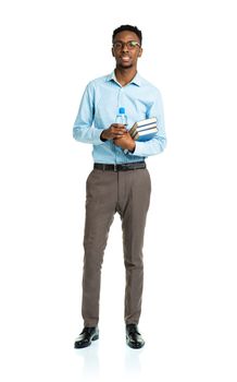 Happy african american college student with books in his hands standing on white background