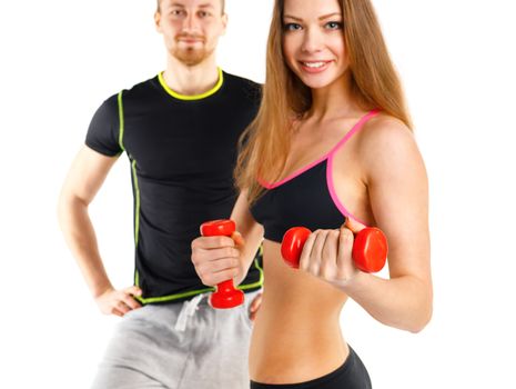 Sport couple - man and woman with dumbbells on the white background