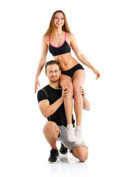 Sports guy holds on shoulder a girl on a white background