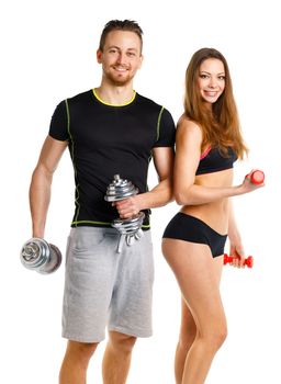 Sport couple - man and woman with dumbbells on the white background