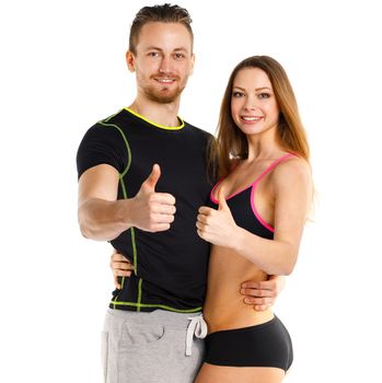 Athletic man and woman after fitness exercise with a finger up on the white background