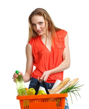 Young caucasian woman with assorted grocery products in shopping basket isolated on white background