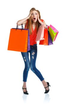 Happy caucasian woman holding shopping bags on white background is shocked. Holidays concept