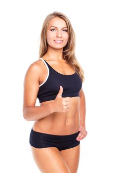 Young athletic girl with a finger up on white background