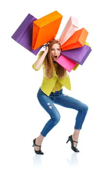 Happy caucasian woman holding shopping bags on white background is shocked. Holidays concept