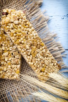 Muesli bars, cereal bars on the wooden background.