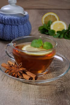 Cup of tea with a slice of lemon, mint and cinnamon