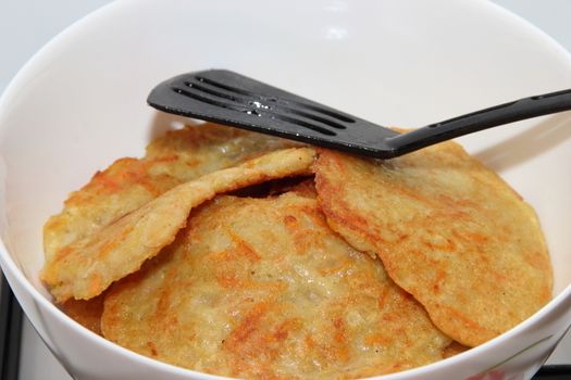 Potato pancakes with sour cream with carrot. Preparation of meals