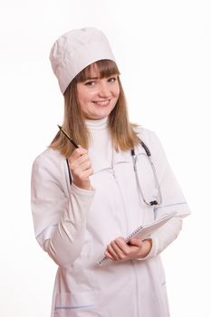 Portrait of medical worker in a white coat, hat, with documents and pen