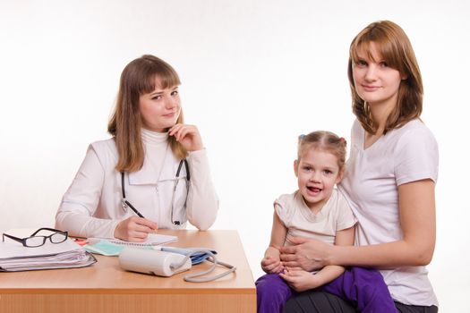 Woman with a small child on reception at the pediatrician
