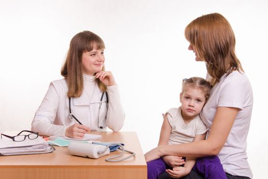 Woman with a small child on reception at the pediatrician