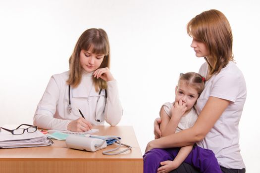 Woman with a small child on reception at the pediatrician