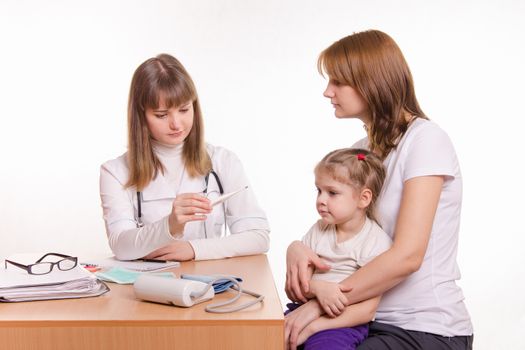 Woman with a small child on reception at the pediatrician