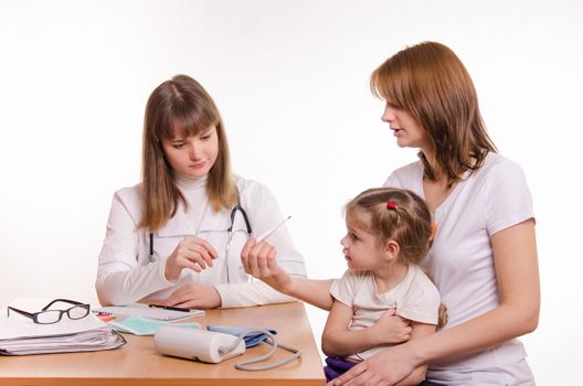 Woman with a small child on reception at the pediatrician