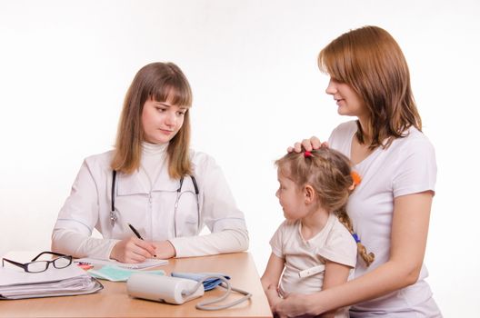 Woman with a small child on reception at the pediatrician