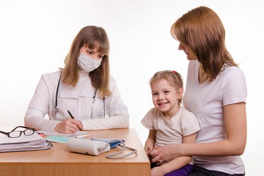 Woman with a small child on reception at the pediatrician