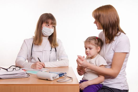 Woman with a small child on reception at the pediatrician