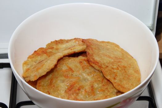 Potato pancakes with sour cream with carrot. Preparation of meals