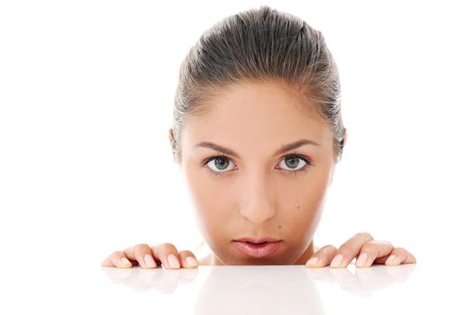 Portrait of a beautiful woman who is hiding and looks like she is playing over a white background