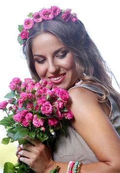 Portrait of a beautiful girl holding bouquet of flowers in the park