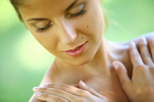 Beautiful young caucasian woman on a green background