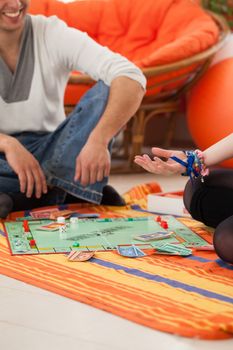 Young caucasian couple playing a game on a floor at home
