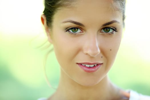 Beautiful young caucasian woman on a green background