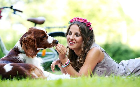 Portrait of a beautiful girl hanging out with a dog in a park