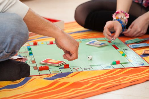 Young caucasian couple playing a game on a floor at home