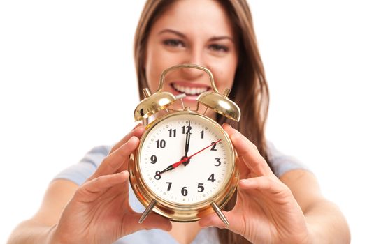 Young caucasian woman with alarm clock in her hands