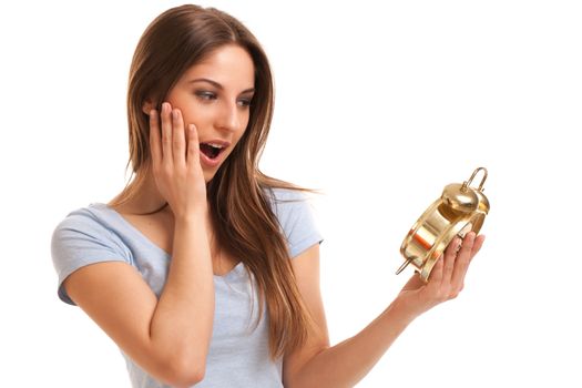 Young caucasian woman with alarm clock in her hands isolated over white background