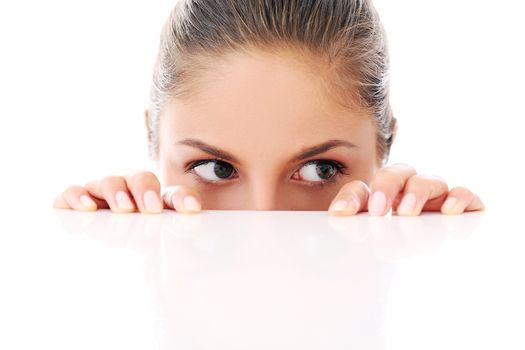 Portrait of a beautiful woman who is hiding and looks like she is playing over a white background