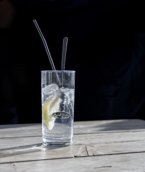 glass tonic on wooden table with lemon fruit