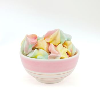 French rainbow meringue cookies on white background with copy space. Macro with shallow dof.