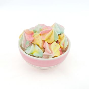 French rainbow meringue cookies on white background with copy space. Macro with shallow dof.