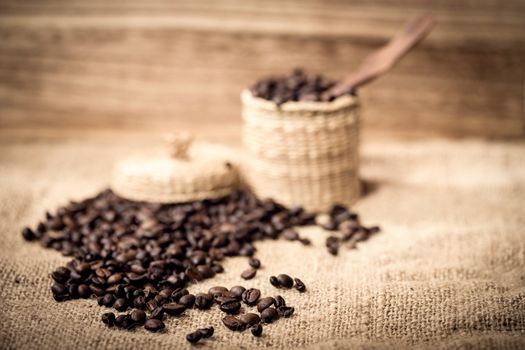 pile of coffee beans and wooden spoon in jar with space for text