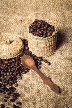 pile of coffee beans and wooden spoon in jar with space for text