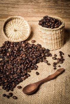 pile of coffee beans and wooden spoon in jar with space for text