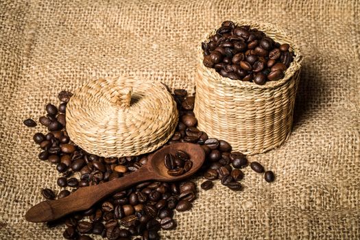 pile of coffee beans and wooden spoon in jar with space for text