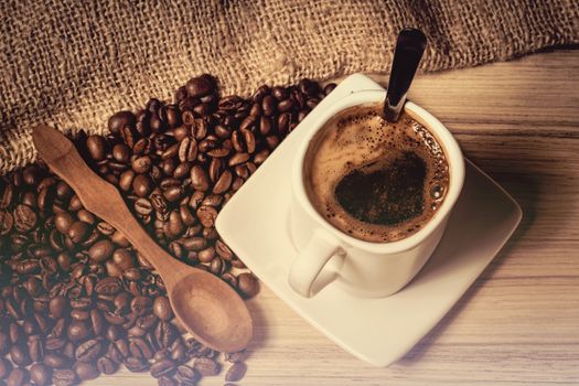 pile of fresh beans, mug, and spoon in retro color tone with space for text
